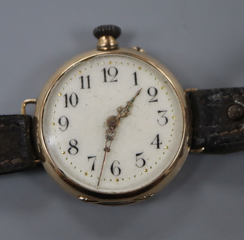 A ladys early 20th century 585 yellow metal manual wind wrist watch, on a leather strap.